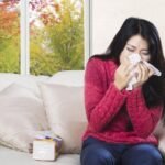 Woman blowing nose